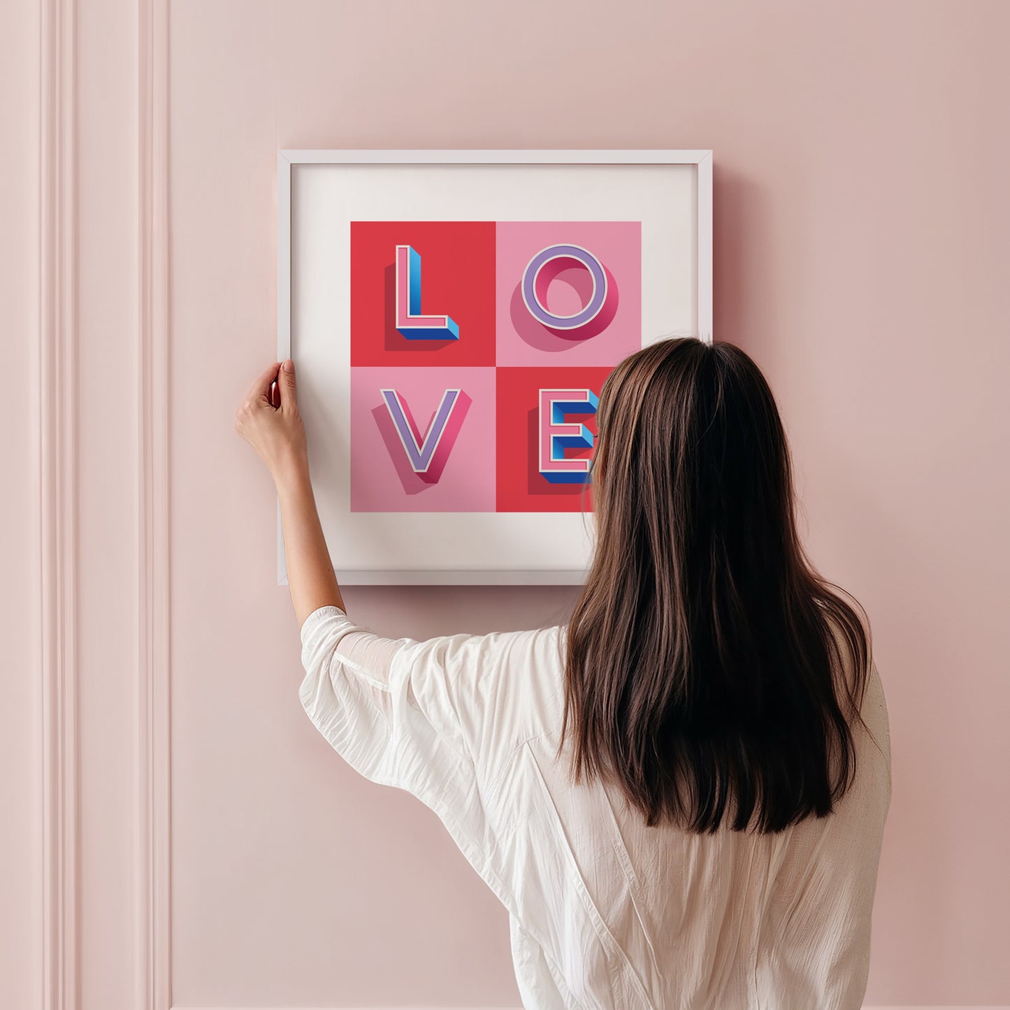 A typographic LOVE Print in Pink and Red check made with love by Alf and Bet being hung on a wall