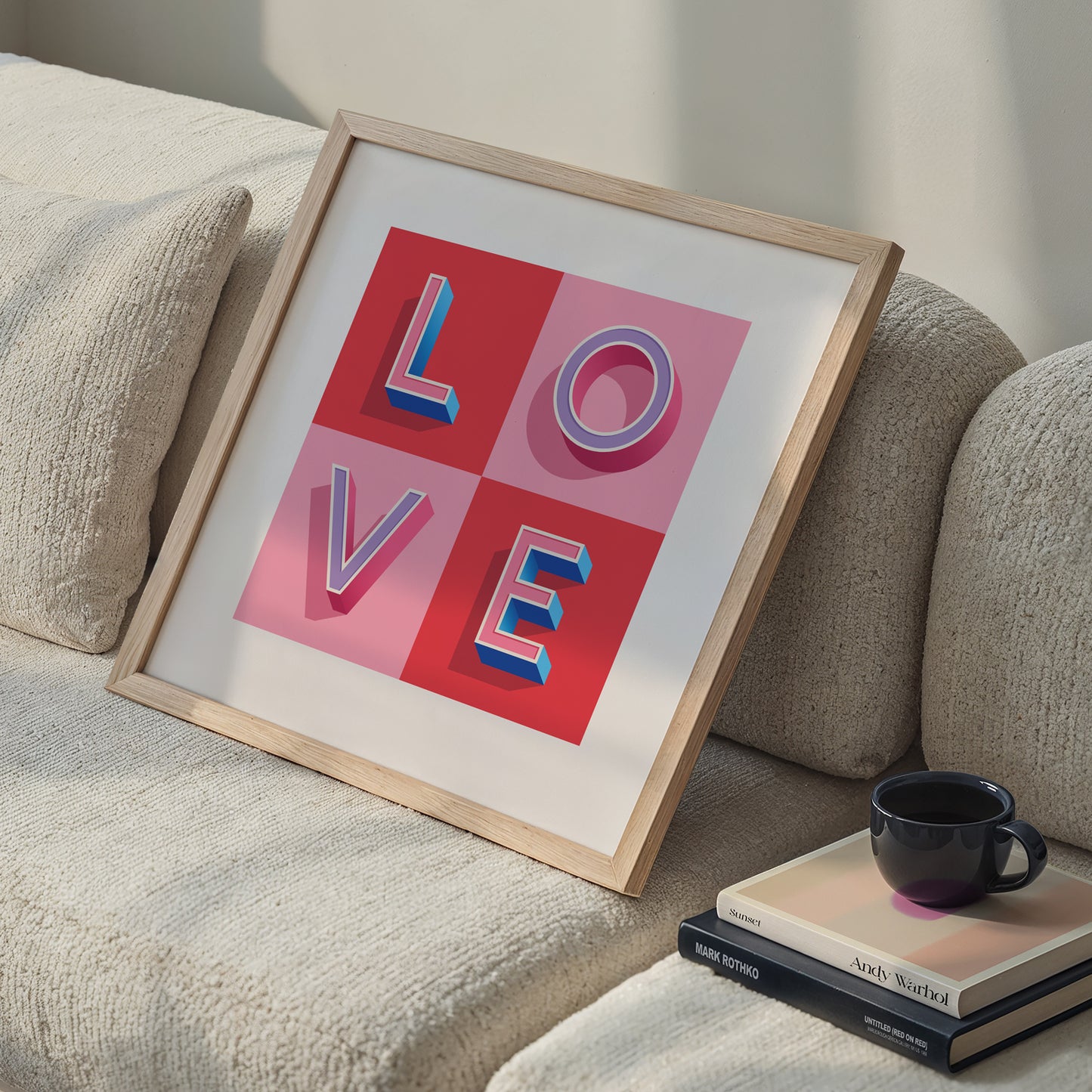 A typographic LOVE Print in Pink and Red check made with love by Alf and Bet displayed on a home office sofa
