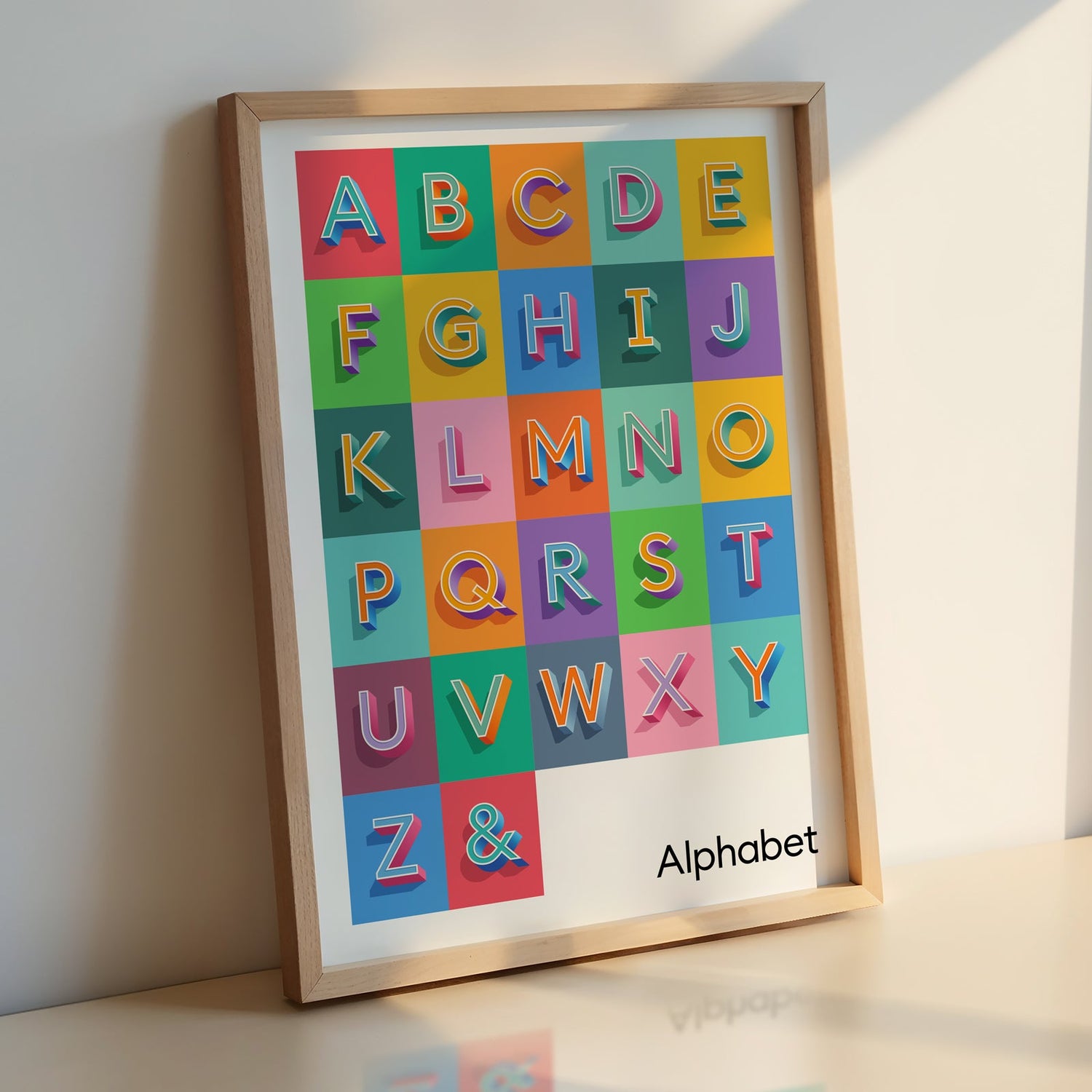 A bold coloured A to Z Alphabet Print from Alf and Bet displayed in a natural wood photo frame