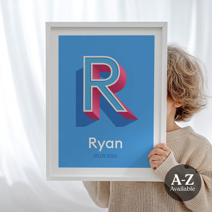 A personalised name and date print from Alf and Bet with a Azure Blue base colour and 3D letter with Sky Blue infill and Deep Pink shadow.